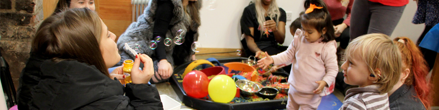 Parents doing sensory play with toddlers